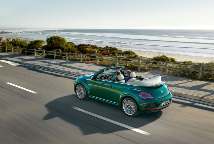 Volkswagen Beetle Cabriolet horní pohled na vůz jedoucí na pobřeží
